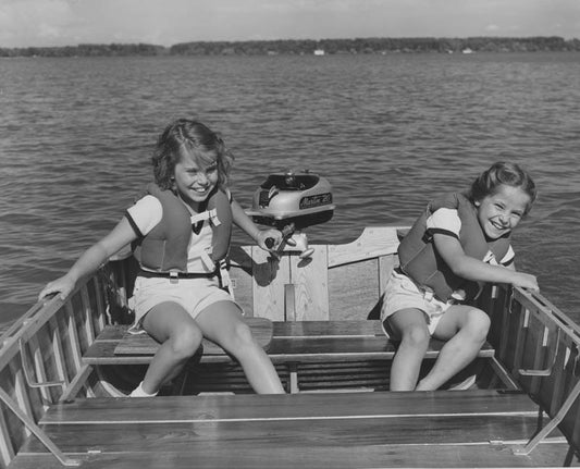 Young Girls Running an Outboard Motor, ca. 1960